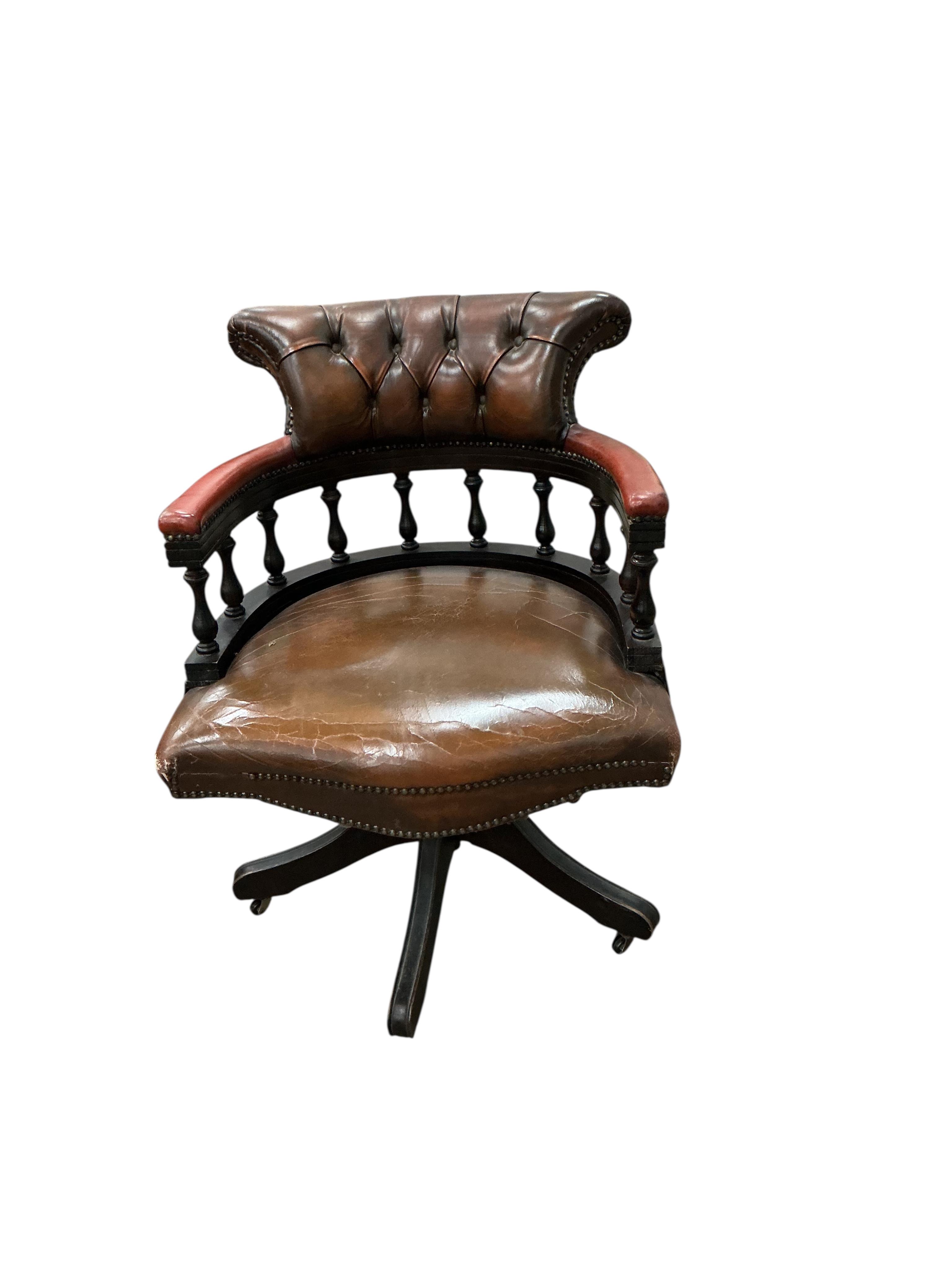 A reproduction yew pedestal desk, width 132cm, depth 61cm, height 77cm and a buttoned burgundy leather swivel desk chair